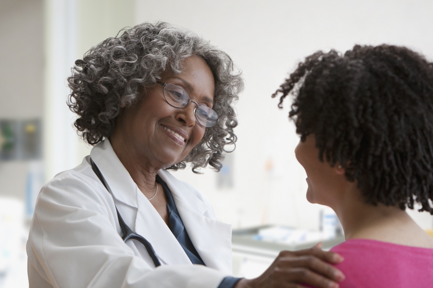 Provider placing hand on patient's shoulder