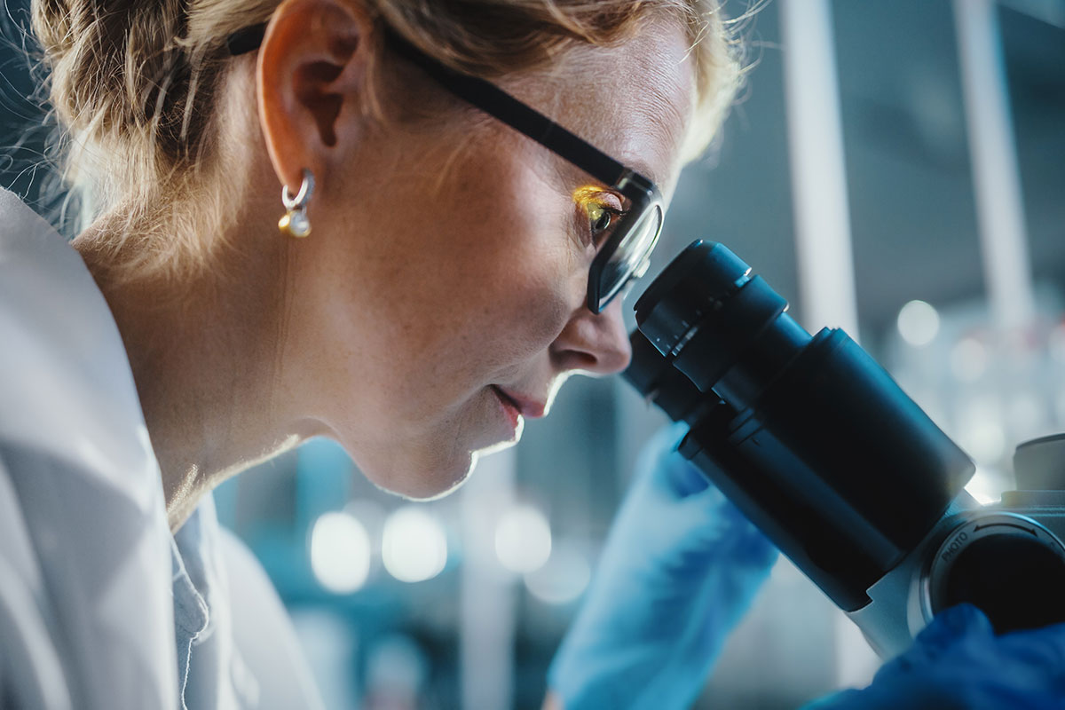 Scientist looking into a microscope