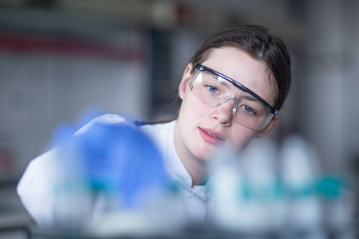 Scientists working in a lab. Examining test tubes